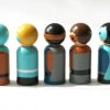 side view of 5 superhero gifts for kids. Superhero boy peg dolls standing in a line. 1 play skinned boy with blond hair, 1 medium skinned boy with a mask, 1 pale skinned boy with brown hair, 1 dark skinned boy with black hair, 1 pain skinned boy with a mask.