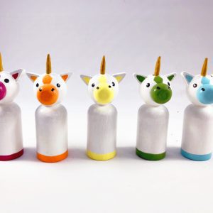 5 miniature rainbow unicorn toys standing in a row. 1 red unicorn, 1 orange unicorn, 1 yellow unicorn, 1 green unicorn, 1 blue unicorn.