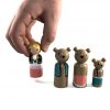 Three Bears wooden figures standing in a row. Goldilocks being held by a Child’s hand. 1 goldilocks, 1 Papa Bear, 1 Mama Bear, 1 Baby Bear