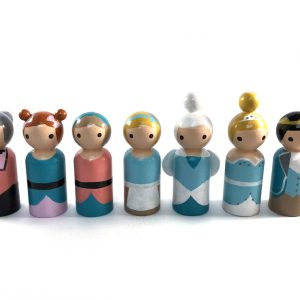 7 Cinderella wooden toy dolls standing in a row. 1 evil stepmother, 2 evil stepsisters, 1 cinderella in rags, 1 fairy godmother, 1 cinderella in fancy dress, 1 prince.