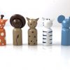 back view of 5 wood safari animal toys standing in a line. 1 elephant, 1 giraffe, 1 lion, 1 zebra, 1 leopard
