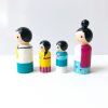 4 Asian family peg dolls standing in a row. 1 mother, 1 boy, 1 girl, and 1 dad