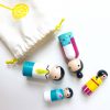 4 Asian family peg dolls laying down, coming out of a bag. 1 mother, 1 boy, 1 girl, and 1 dad