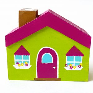 1 green, little wooden block house standing.
