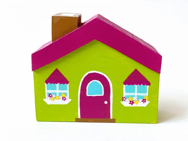 1 green, little wooden block house standing.