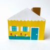 1 yellow, wooden peg doll house standing.