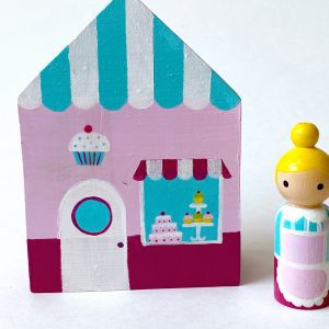 1 wooden bakery block toy and one female bakery worker standing.