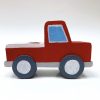 side view of red vintage wood truck toy