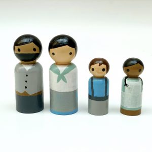 4 old style wooden toys standing in a row. 1 medium skinned man with black hair, 1 pale skinned woman with black hair, 1 pale skinned boy with brown hair, 1 dark skinned girl with black hair.